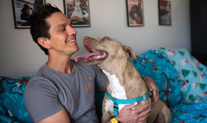 Adam with Queenie the dog on a sleepover