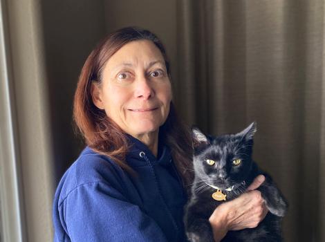 Alida Collewyn holding Felix, her black cat