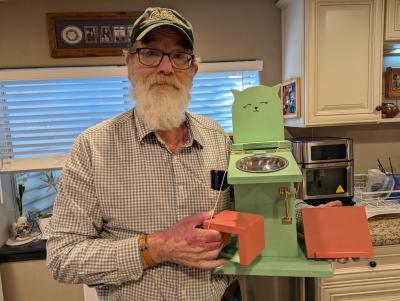 Kerk Phillips holding another chair that he made for a kitten with megaesophagus