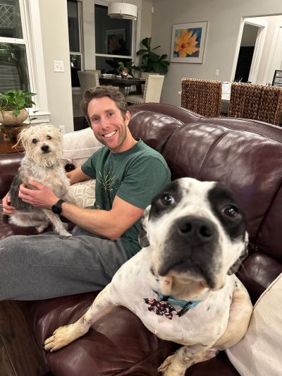 Apollo the dog with a man and another dog in his foster home