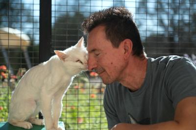 Bae the cat nuzzling Mike's face
