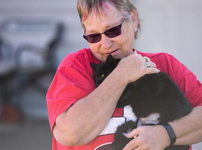 Community member holding a cat.