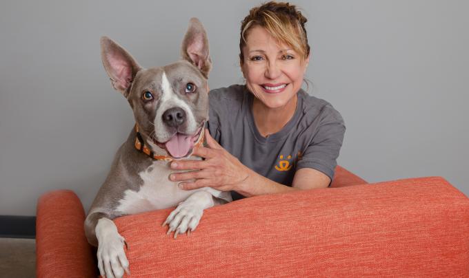 Smiling person wearing a Best Friends T-shirt next to a smiling dog with upright ears