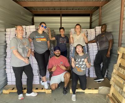 Group of people inside truck with pet food donations