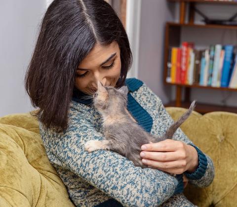 Woman cuddling her kitten foster