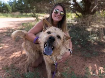 Woman outside with a dog.