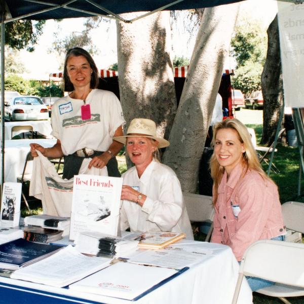 Two volunteers and co-founder Diana Asher table at the Los Angeles Equestrian Center, 1996.