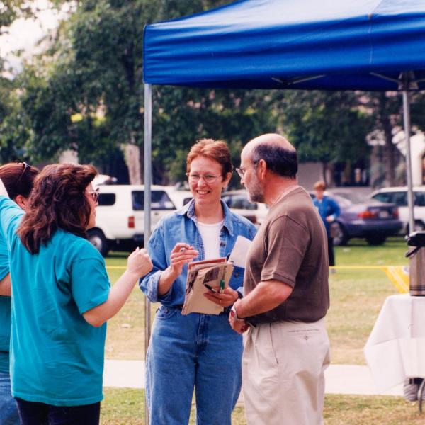 Co-founders Francis and Silva Battista speak with benefit attendees, 1998.