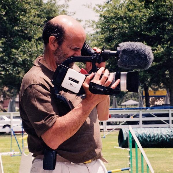 Co-founder Francis Battista films at the Equestrian Center Benefit, 1998.