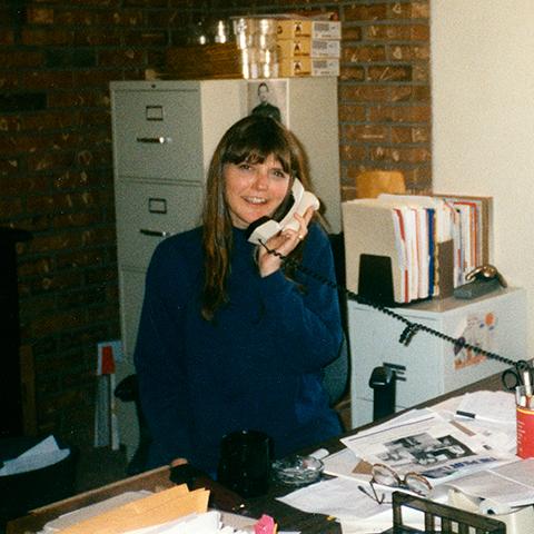 Estelle Munro at a desk on a phone