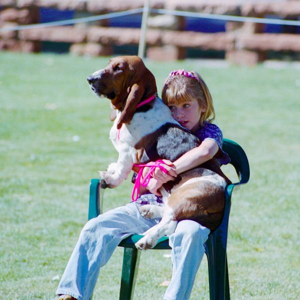 A girl and her Basset Hound compete for ‘Best Lap Dog” at Strut Your Mutt,1995.