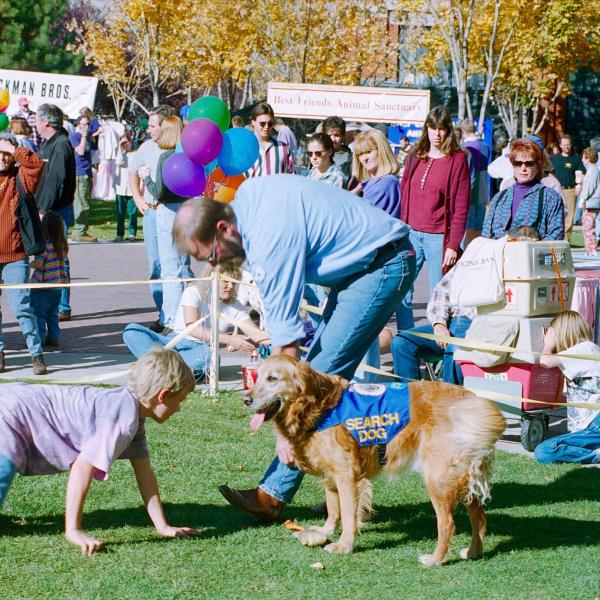 A child participates in a search dog demonstration during Strut Your Mutt, 1995.