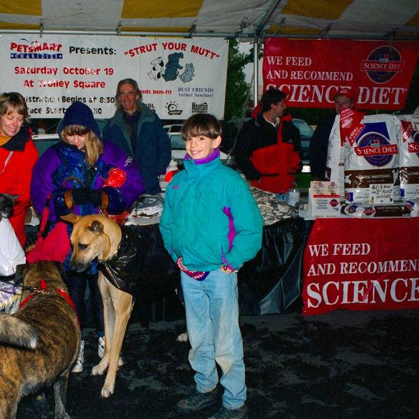 Strut Your Mutt participants shelter from the rain under the vendor tent in Salt Lake City, 1996.