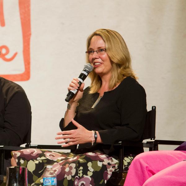 Julie Castle speaking on stage next to Mike Arms at the 2012 No More Homeless Pets Conference.