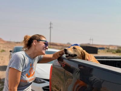 Person petting a dog in a pickup at the Best Friends’ mobile clinic at the Navajo Nation
