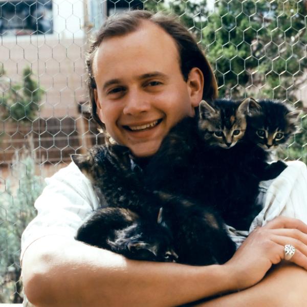 Co-Founder Judah Battista with abandoned kittens found locally under a wood pile.