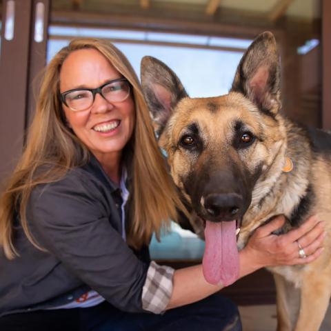 Julie Castle next to large brown dog