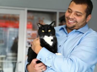 Smiling person holding a cat