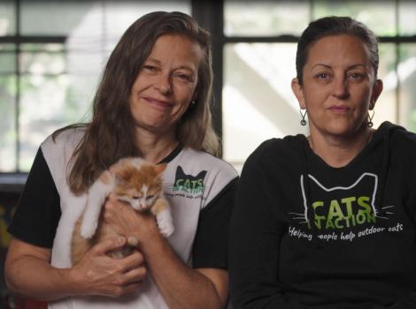 Liz and Erica, with one holding a cat
