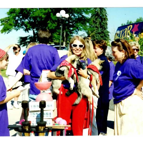 Volunteers enjoy some puppies at the launch of No More Homeless Pets in Utah, 2000.