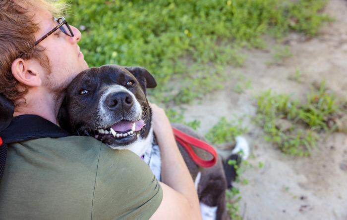 Polly outside getting a hug from a person
