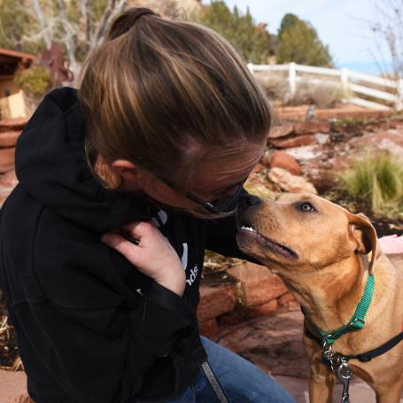 Person and dog outside of the Best Friends Welcome Center