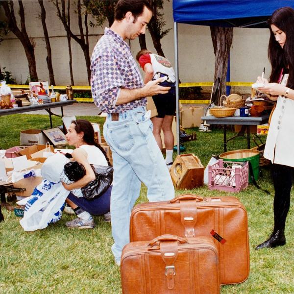A volunteer keeps track of sales at an LA yard sale to benefit the Sanctuary.